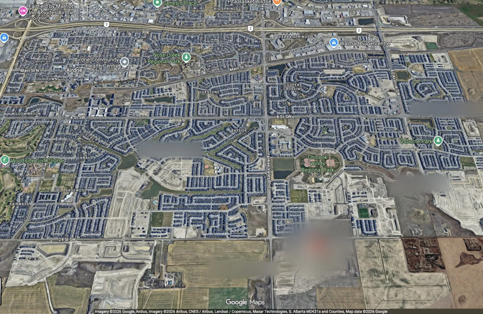 Aerial view of SW Airdrie, with Highway 2, established neighbourhoods and the area of the new homes circled